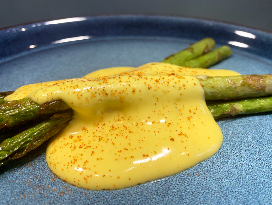 Hollandaise sauce on pan seared asparagus